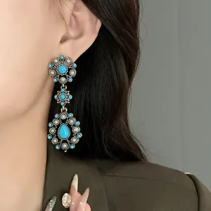 Detailed view of vintage bohemian flower earrings with turquoise stones and pearls