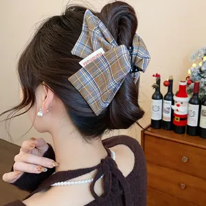 Close-up of a stylish plaid fabric hair claw clip styled in an elegant updo