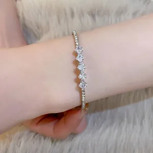 Dettaglio di un bracciale in argento minimalista con cinque pietre di zirconia quadrate
