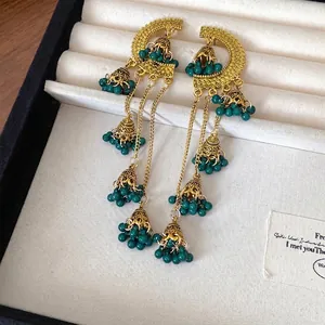 Retro ethnic style bell tassel earrings featuring green beads and elegant gold-tone metal