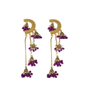 Vintage ethnic style gold tassel earrings with intricate bell charms and purple beads decorations