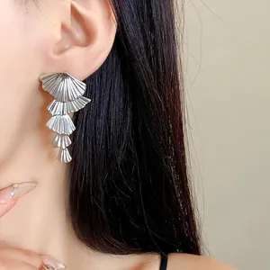 Elegant silver-toned multi-layered fan-shaped drop earrings for fashionable women.