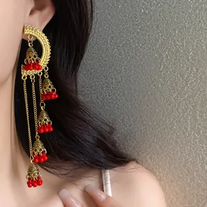 Vintage ethnic style bell tassel earrings with vibrant red beads and gold filigree design