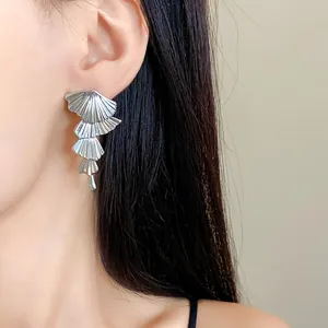 Elegant close-up of stylish multi-layered fan-shaped drop earrings with silver finish