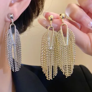 Detailed view of elegant gold and silver bead chain tassel earrings with V-shape design