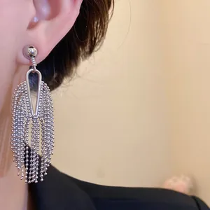 Detailed view of silver-tone irregular beaded tassel earrings with a vintage finish