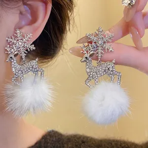 Elegant silver reindeer earrings with sparkling rhinestones and white fur balls for winter