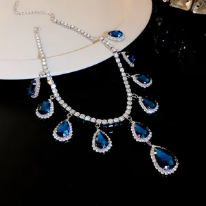 Detailed close-up of a luxury blue teardrop crystal necklace with shimmering pavé stones