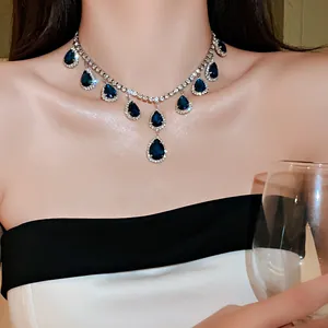 Elegant silver-tone necklace featuring teardrop blue crystals surrounded by clear rhinestones