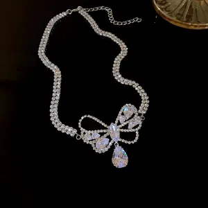 Detailed view of elegant silver bow necklace featuring a sparkling teardrop zircon pendant charm