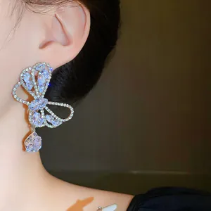Close-up of elegant butterfly drop earrings with sparkling cubic zirconia crystals