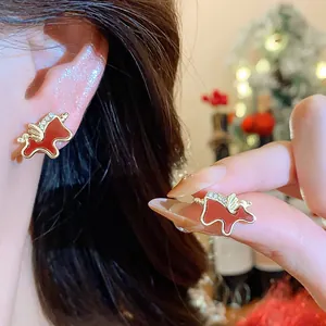 Detailed view of red enamel horse stud earrings with crystal accents for New Year gift