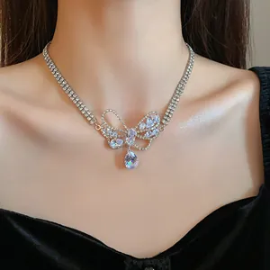 Close-up of elegant silver butterfly necklace with sparkling zirconia stones on model