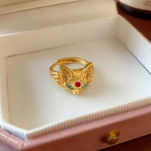 Detailed view of a vintage gold plated fox head ring with zircon stones in a gift box