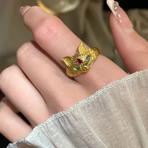 Close-up detail of vintage gold-plated fox ring featuring colorful zircon accents