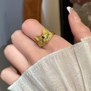 Close-up detail view of a 24K gold-plated fox open ring with colorful zircon stone eyes