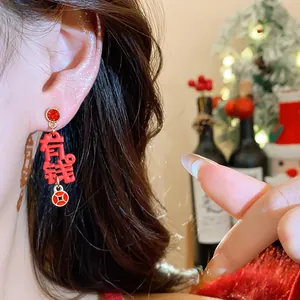Close-up of festive red Chinese character earrings with rhinestones for the Lunar New Year
