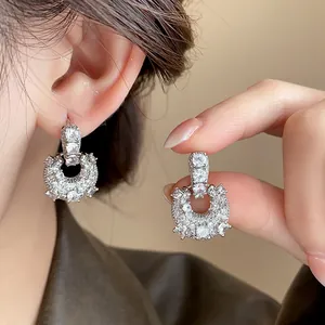 Detailed view of luxury silver-tone U-shaped hoop earrings with shimmering cubic zirconia