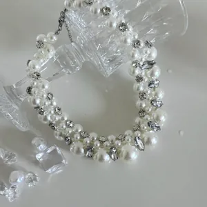 Close-up of elegant French retro pearl choker necklace with rhinestone accents