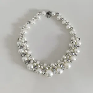 Detailed close-up of a French vintage pearl choker necklace with inlaid clear rhinestones