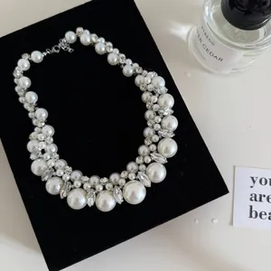 Close-up of elegant French pearl and rhinestone beaded necklace on black velvet