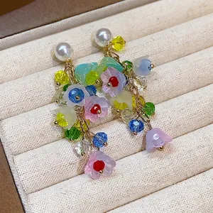 Elegant colorful resin flower tassel earrings featuring pearls and sparkling crystals.