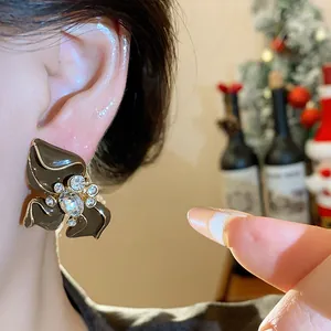 Close-up detail of retro brown enamel flower stud earring with sparkling crystal center