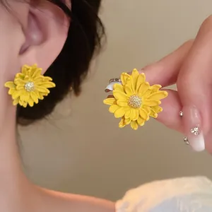 Detailed view of yellow daisy flower stud earrings for a sweet and fresh forest style look