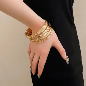 Elegant multi-layer gold metal bangles for women featuring geometric minimalist style