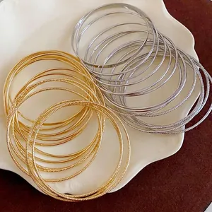 Minimalist multi-layer metal bangle bracelets set in elegant gold and silver finishes