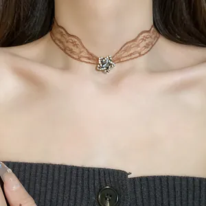 Close-up of elegant brown lace choker necklace with a sparkling crystal star pendant