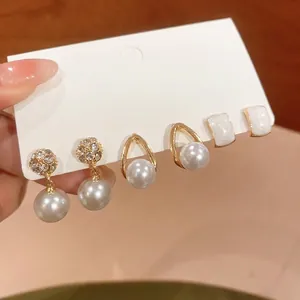 Detail view of French style pearl earring set with gold-tone plating and rhinestones