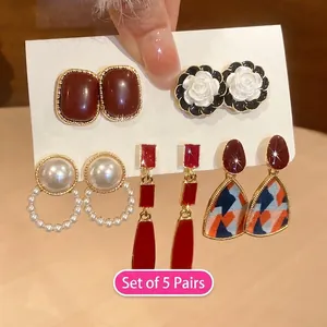Detailed view of 5-pair vintage style earring set featuring camellia flowers and pearls