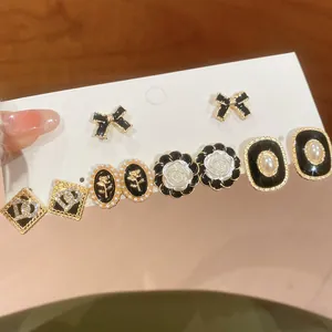 Close-up of elegant pearl and rose stud earring set in French vintage style
