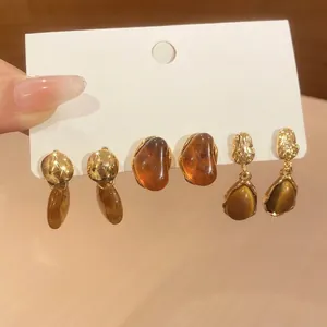 Close-up of vintage amber resin gold earring set featuring French elegant design