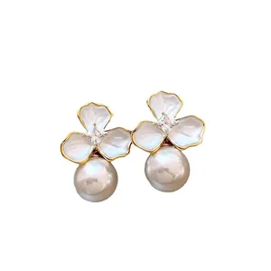 Elegant flower stud earrings with white petals, zircon center, and round pearls