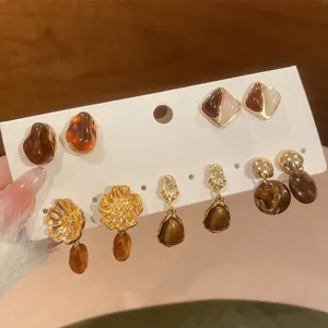Detail shot of elegant French vintage earring set with floral and amber resin designs