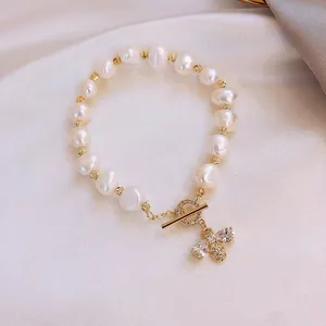 Detailed view of freshwater pearl bracelet with micro-pave bee charm and toggle clasp.