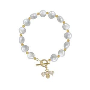 Elegant freshwater pearl bracelet featuring a micro-set bee charm and T-bar clasp