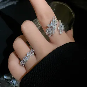 Primo piano di anello a foglia in zircone scintillante e anello sovrapposto.