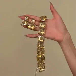 Detailed view of oversized champagne square crystal necklace and earrings jewelry set