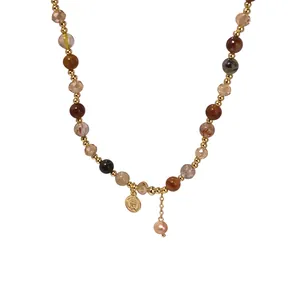 Elegant multi-color crystal beaded bracelet with gold portrait coin and baroque pearl drop.