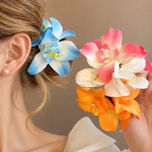 Vacation style fabric flower hair clips in blue, pink, and orange gradient petals