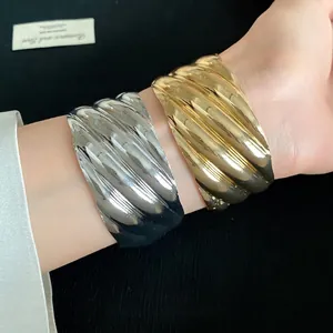 Chunky wavy textured metal open bangles in gold and silver finish for women's fashion