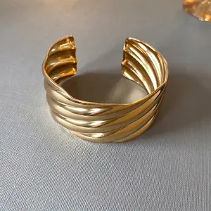 Gold plated wave textured open cuff bracelet with minimalist aesthetic for women