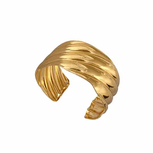 Stylish golden wave-textured open cuff bracelet with a minimalist metallic finish