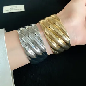 Stylish wave-textured metallic open cuff bracelets in polished gold and silver