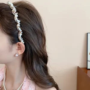 Close-up view of a retro acrylic irregular stone headband worn by a female model.