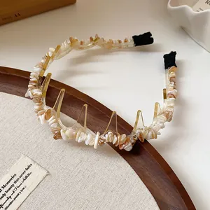 Close-up of the elegant acrylic headband with irregular amber stone chips detail