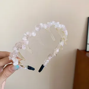 Detailed view of pink crushed stone headband with wavy acrylic prongs for hair volume